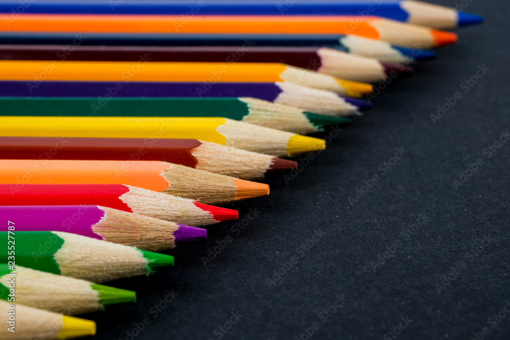 Color pencils on black background close up. Color pencils on black background close up.