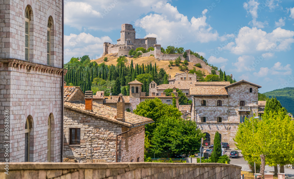 Scenic view in Assisi with the Rocca Maggiore and olive trees. Umbria, Italy.