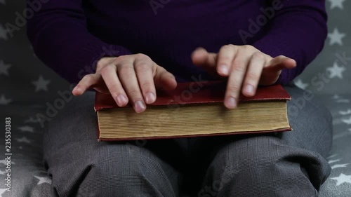 Close-up women's hands are nervous, old book photo