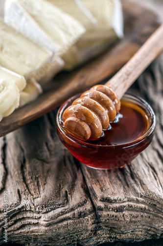 Baked camembert with honey on a beautiful old wooden background