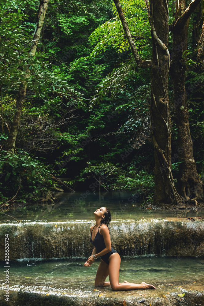 Sexy woman in the jungle with beautiful waterfall Sexy woman in the jungle with beautiful waterfall
