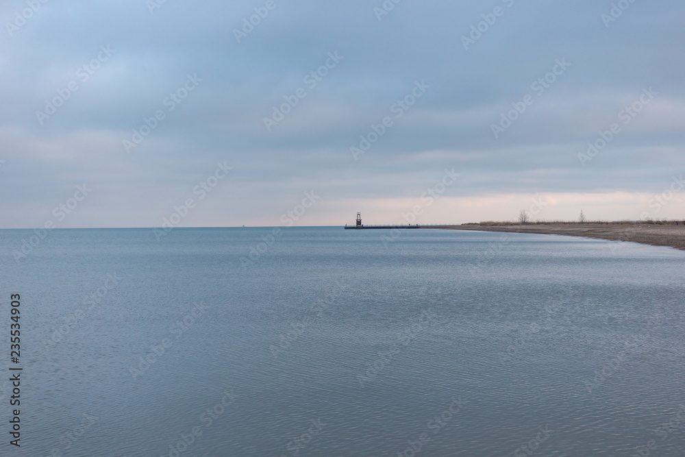 Lighthouse protruding out into Lake Michigan