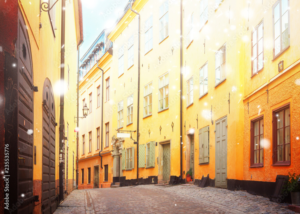 view of old town street in Stockholm at sunny day with snow, Sweden