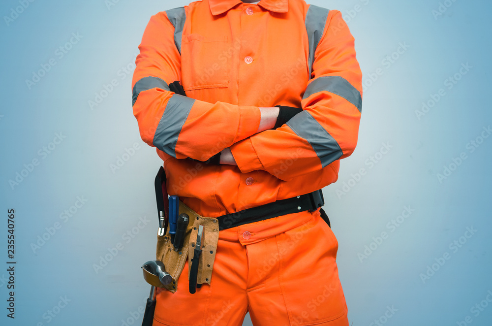 Builder construction worker holding his hands crossed on his chest. Safety at work concept. Builder construction worker holding his hands crossed on his chest. Safety at work concept.
