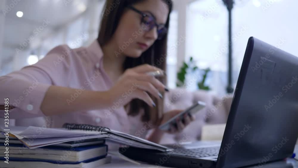business freelance, successful woman uses modern computer technology and smartphone for remote work to development of business ideas and making notes in notebook close-up sitting at table indoors business freelance, successful woman uses modern computer technology and smartphone for remote work to development of business ideas and making notes in notebook close-up sitting at table indoors
