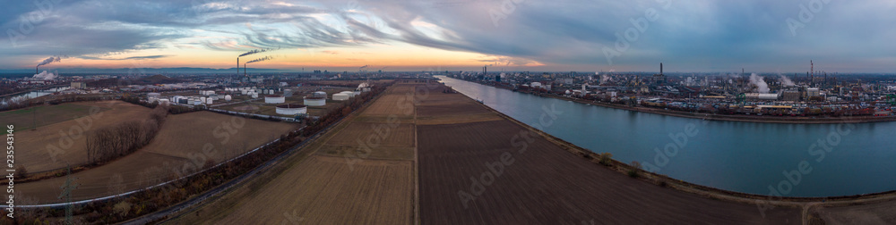 Industrial landscape with the river Rhine and chemical production plants at Mannheim and Ludwigshafen in Germany.