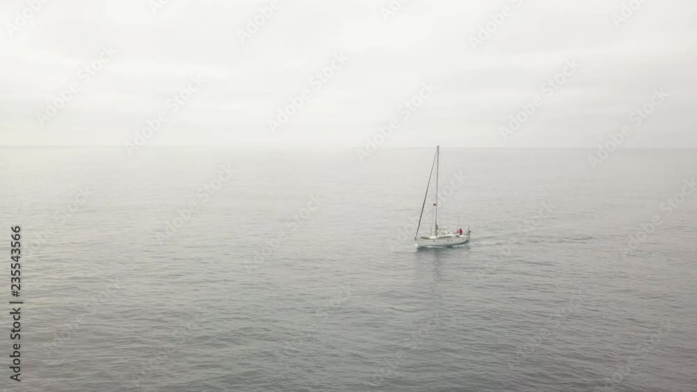 Drone view sail yacht floating in sea while cloudy day and overcast sky on background Drone view sail yacht floating in sea while cloudy day and overcast sky on background