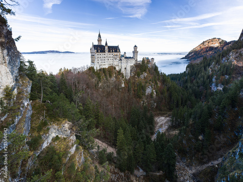 German Fairytale Castle in autumn above sea of clouds