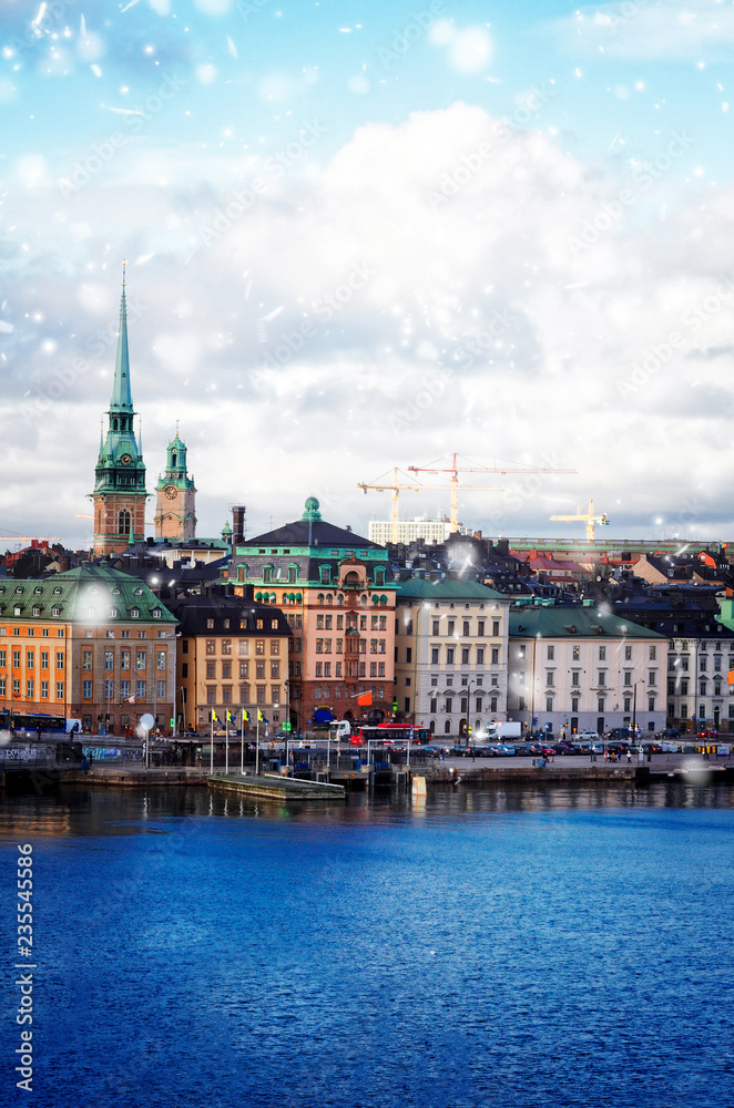 Fototapeta premium old town waterfront and ships of Stockholm with snow, Sweden