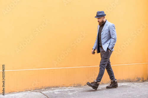 stylish man with a beard and a hat near the desirable wall © Дмитрий Королев