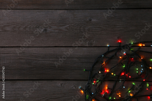 Christmas garland lights on grey background, copy space