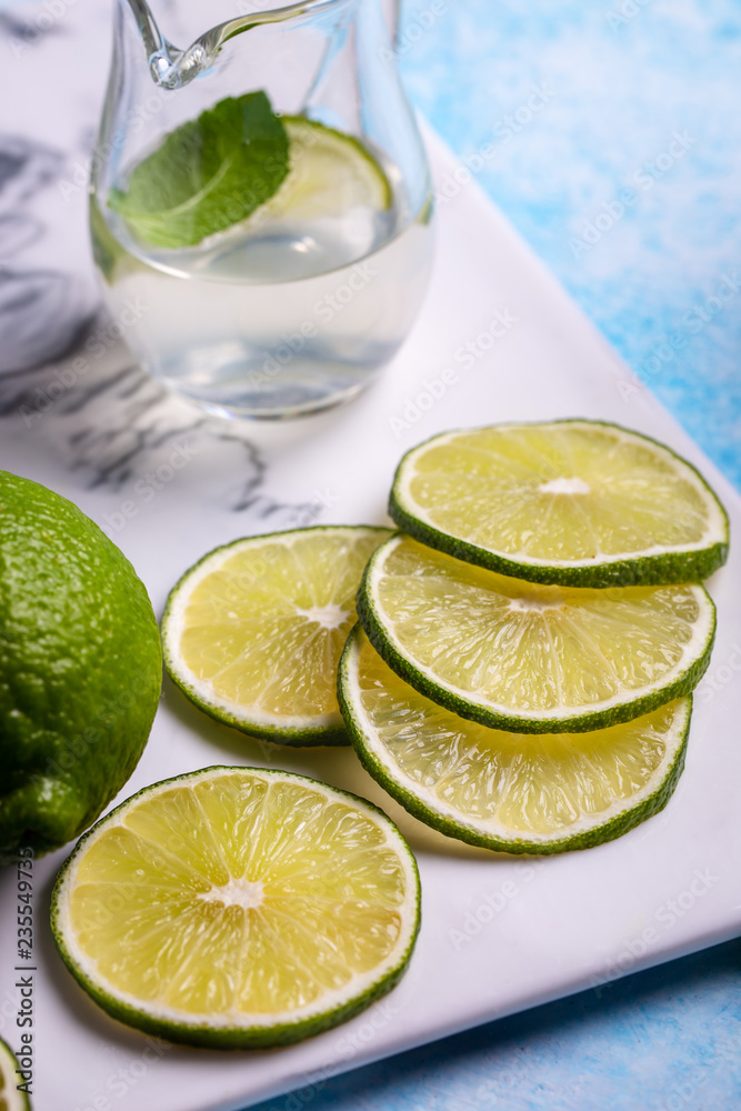 Sliced lime and juice on ceramic platter closeup Sliced lime and juice on ceramic platter closeup