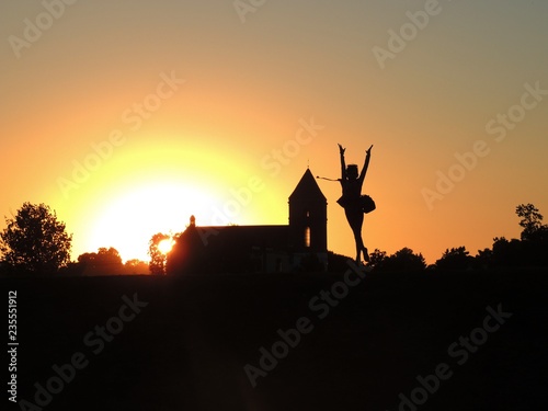 Church and girl in the sunset