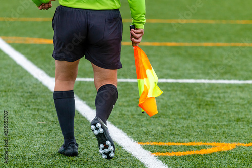 Assistant referee hold flag.