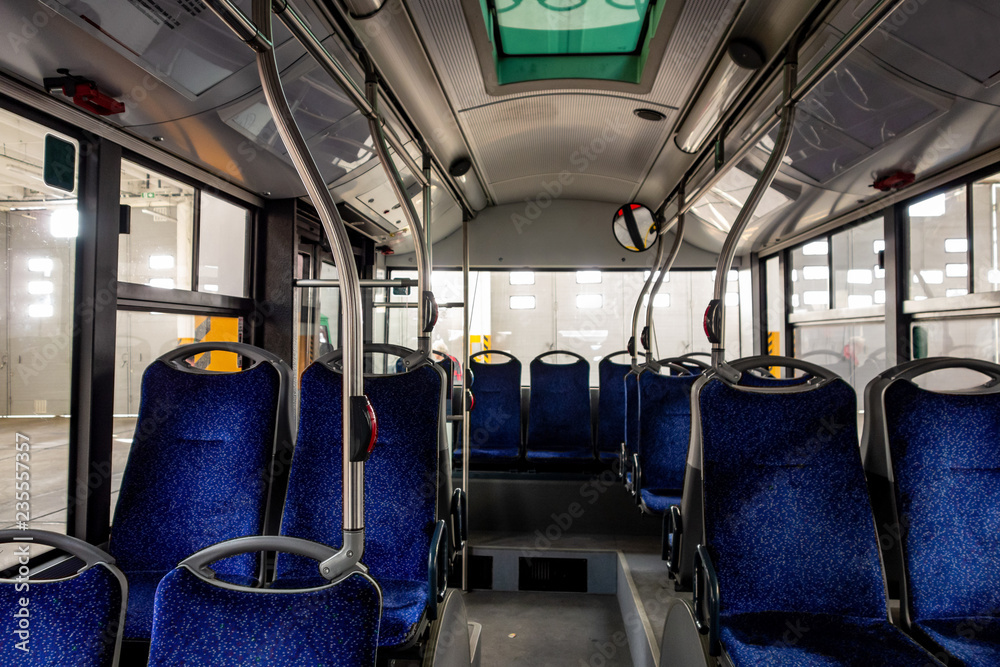 Interior of a modern city bus with blue seats Interior of a modern city bus with blue seats