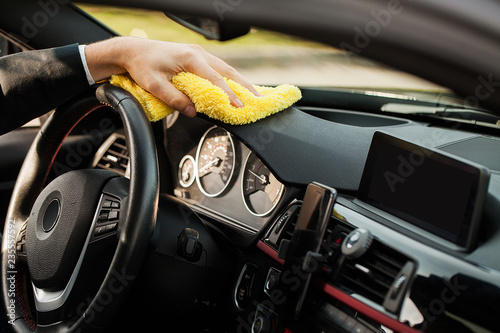 Cleaning car. Hand with microfiber cloth cleaning car interior