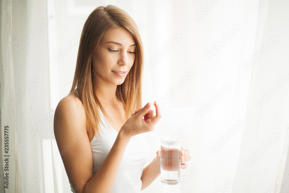 Vitamins and Supplements. Woman taking a tablet. Close up hand with a pill and the mouth. Vitamins and Supplements. Woman taking a tablet. Close up hand with a pill and the mouth.