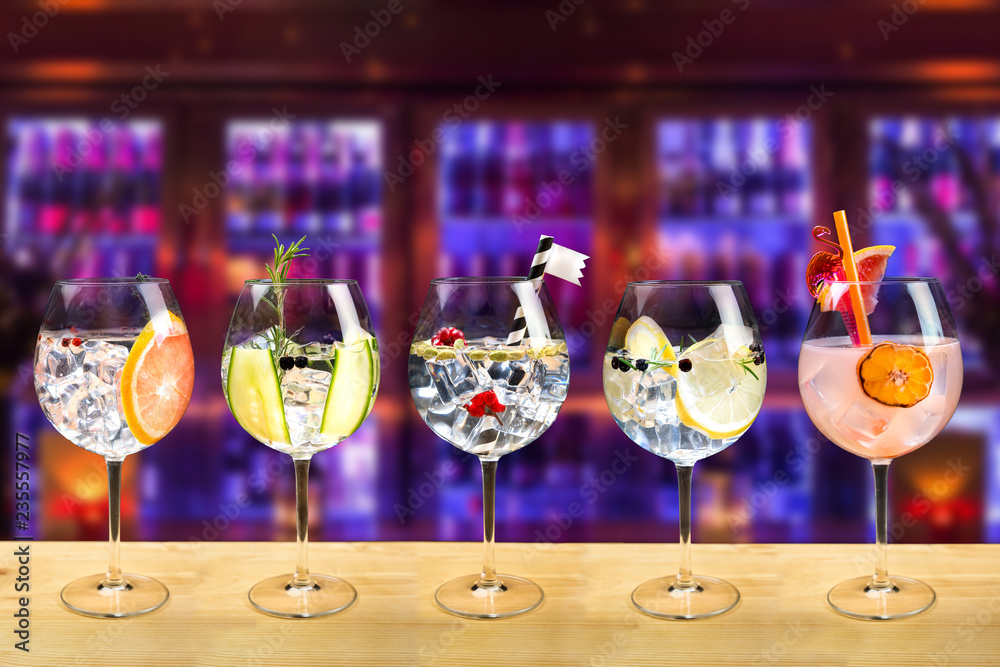 Gin and tonic mixed cocktail drinks various selection garnish bartender bar background fashion trendy
