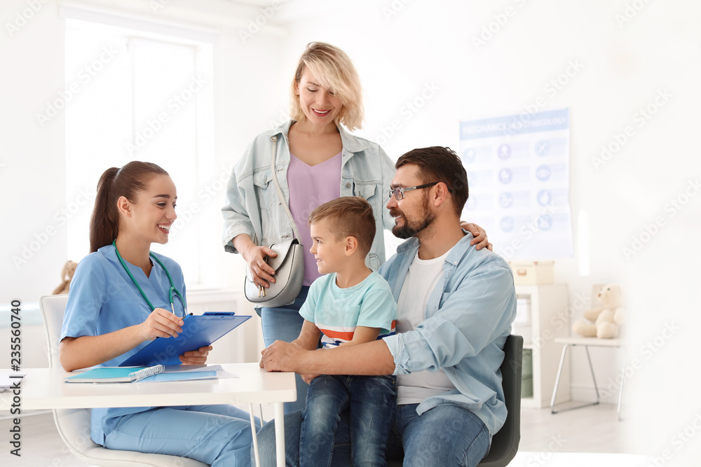 Little boy with parents visiting children's doctor in hospital