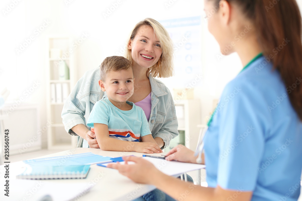 Little boy with mother visiting children's doctor in hospital Little boy with mother visiting children's doctor in hospital