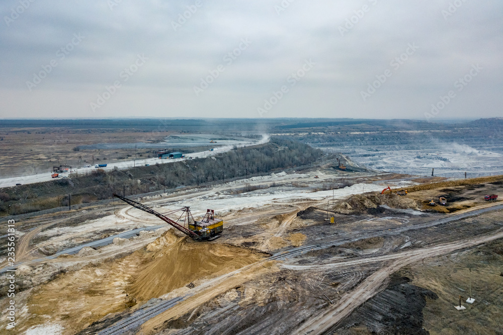 Open pit mine, aerial view from drone. Working excavators and dump trucks Open pit mine, aerial view from drone. Working excavators and dump trucks