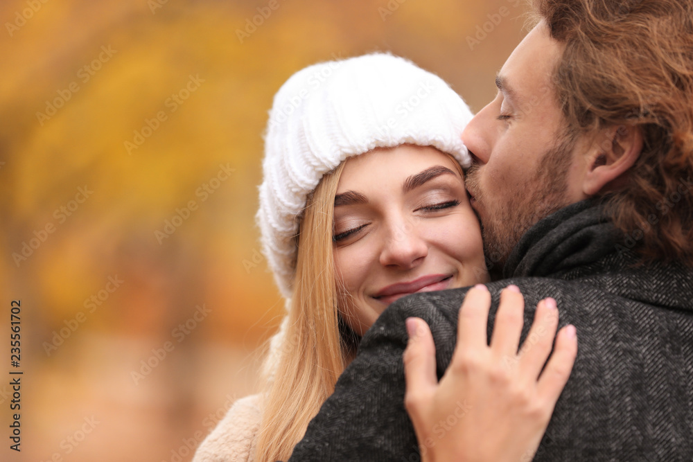 Fototapeta premium Young romantic couple hugging outdoors on autumn day
