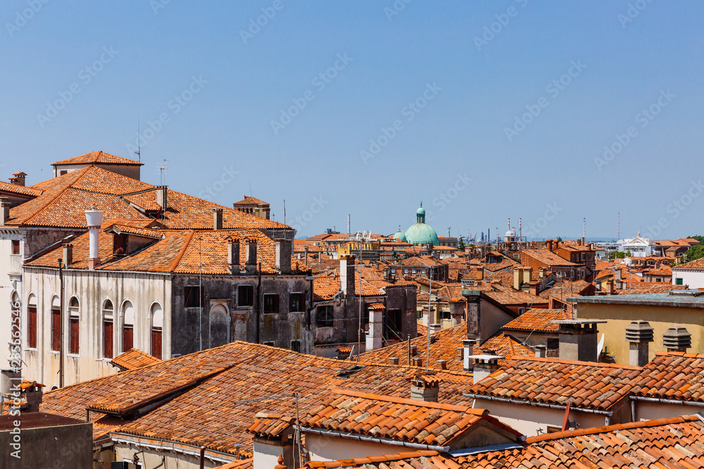 Terracotta rooftops of venetian houses under blue sky in Venice, Italy Terracotta rooftops of venetian houses under blue sky in Venice, Italy