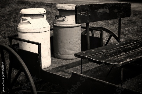 Old milk jugs on a wagon.