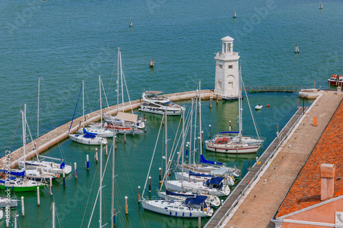 Lighthouse and boats near the island of San Giorgio Maggiore, in Venice, Italy
