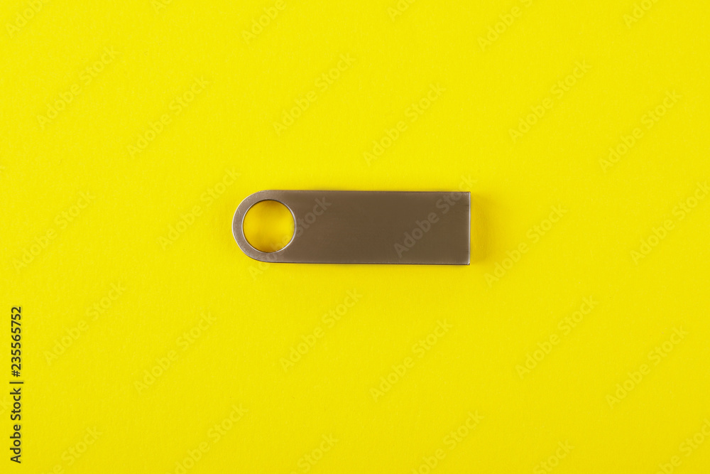 Silver usb flash drive, flash card on yellow background Silver usb flash drive, flash card on yellow background