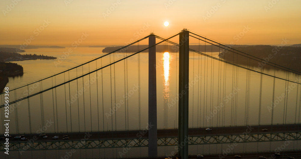 Sun Heads for the Horizon over Tacoma Narrows Bridges