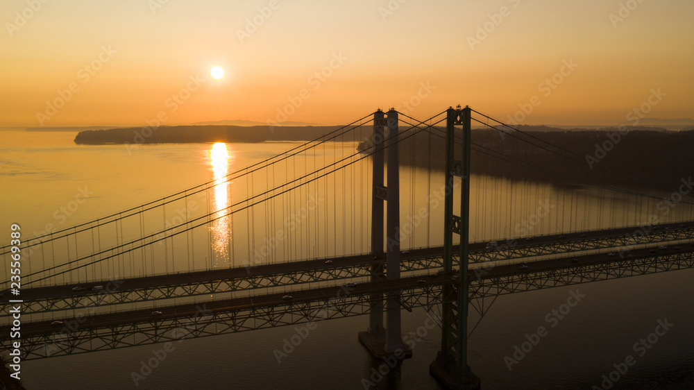 Sun Heads for the Horizon over Tacoma Narrows Bridges