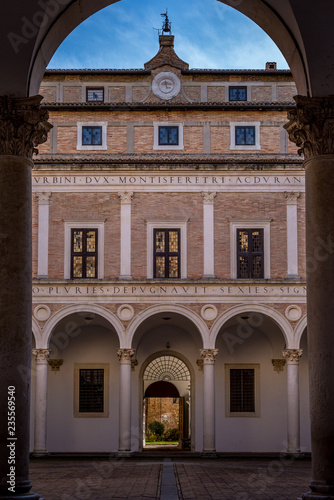 View of the court yard in the medieval Ducal Palace of Urbino  in Marche Italy with clock and old columns