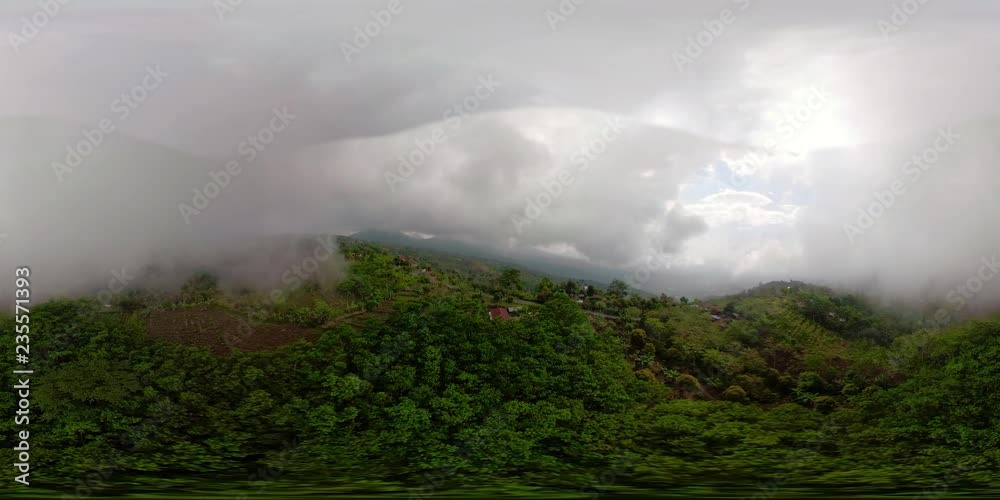 vr360 clouds and fog in mountains farmers land with agricultural crops. Aerial view farmlands, fields with crops, trees. mountains are covered with forest. Indonesia. vr360 clouds and fog in mountains farmers land with agricultural crops. Aerial view farmlands, fields with crops, trees. mountains are covered with forest. Indonesia.