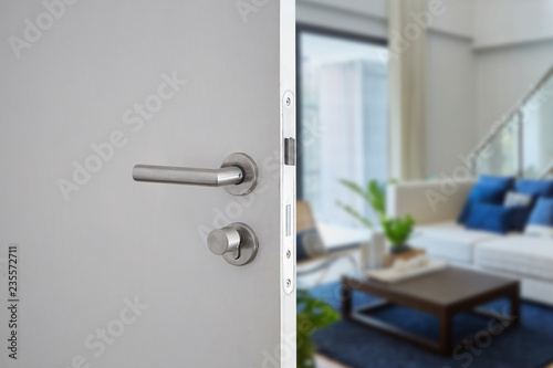 Door handle , door open in front of blur interior room background, selective focus photo