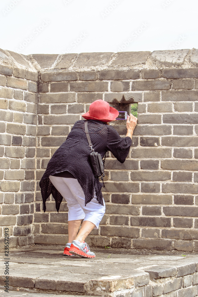 A Middle Aged Caucasian Lady Posing on Top of The Great Wall of China at Jinshanling A Middle Aged Caucasian Lady Posing on Top of The Great Wall of China at Jinshanling