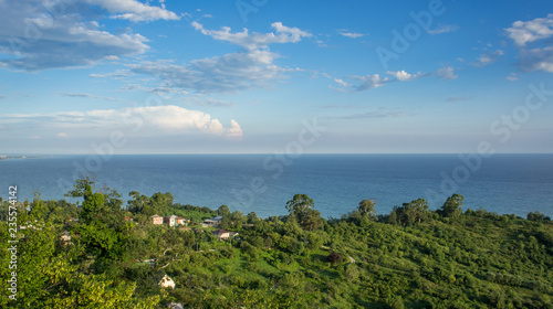 Seascape with a view of the green coastline.