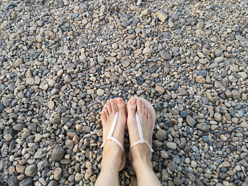 Fashion Beautiful Woman Wearing Nude Sandals on Stone. Female Standing. Hipster Top View Selfie of Legs and Feet on Rock Background