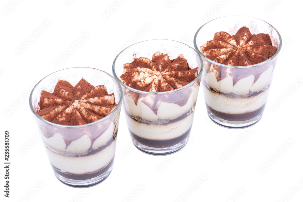 Sweet Italian dessert tiramasu with delicate mascarpone cream from traditional recipe in glass isolated on white background Sweet Italian dessert tiramasu with delicate mascarpone cream from traditional recipe in glass isolated on white background
