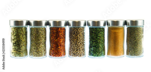 collection of spice and herbs seasoning in glasses bottles isolated on white background