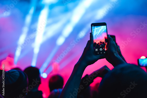 spectators at a concert phone close-up live broadcast