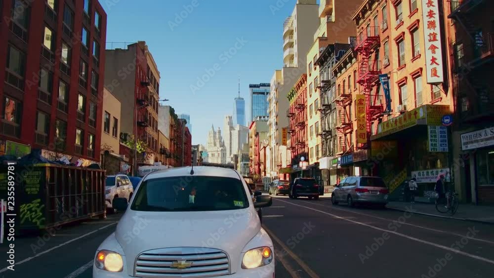 NEW YORK CITY, USA - OCT 30, 2018: Cross walk street with skyscrapers in Chinatown in downtown Manhattan. 