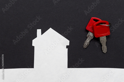 an image of a house with keys on dark background