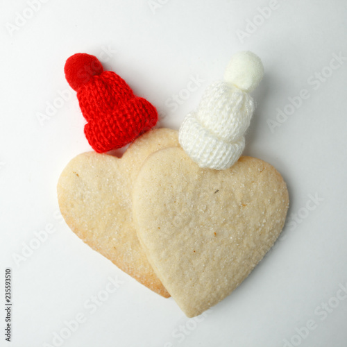 Christmas New Year  winter Saint valentine Celebration Decorations Concept  homemade ginger bread heart with decorative red and white hat on white background  concept of love