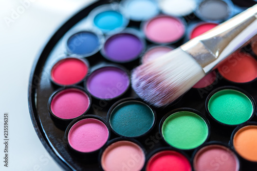 Eyeshadow Colorful pastel cosmetics and make up plate with brush, Copy space. Lifestyle Beauty Concept
