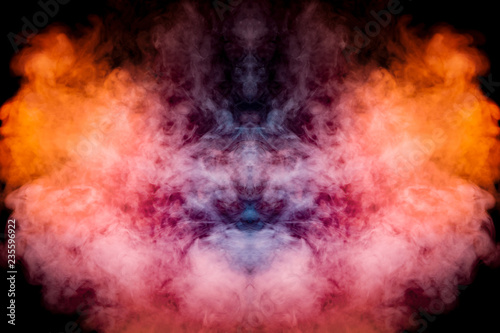 A background of blue, red and orange wavy smoke in the shape of a ghost's head or a man of mystical appearance on a black isolated ground. Bright abstract pattern of steam from vape.