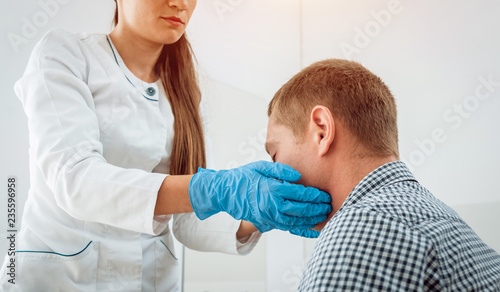 Otolaryngologist examines man s throat. Medical equipment