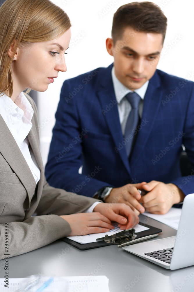 Business people using laptop pc while discussing project in office. Successful meeting and negotiation concepts Business people using laptop pc while discussing project in office. Successful meeting and negotiation concepts