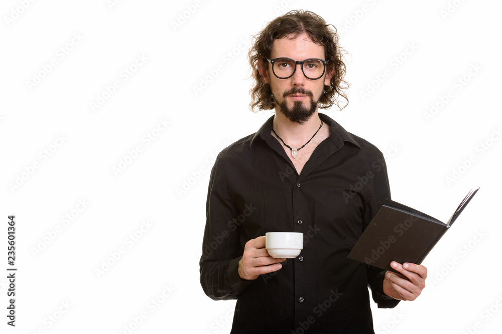 Handsome Caucasian man holding book and coffee cup Handsome Caucasian man holding book and coffee cup