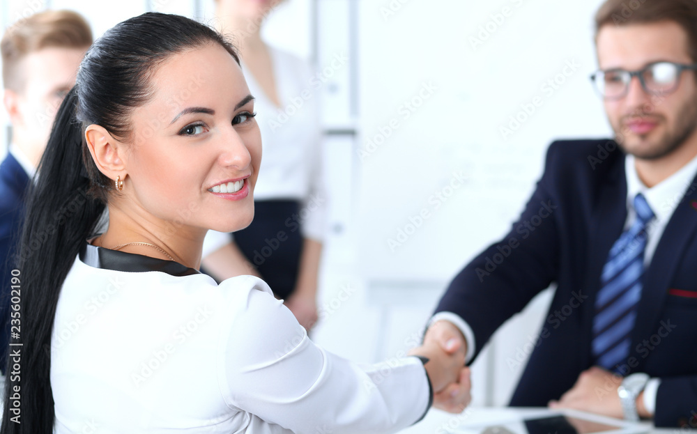 Fototapeta premium Business handshake at meeting or negotiation in the office. Two businesspeople partners are satisfied because signing contract or financial papers